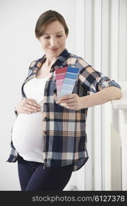 Pregnant Woman Choosing Color Scheme Fort Baby&rsquo;s Room