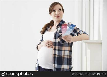 Pregnant Woman Choosing Color Scheme Fort Baby&rsquo;s Room