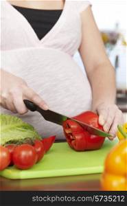 Pregnant Woman Chopping Up Fresh Vegetables