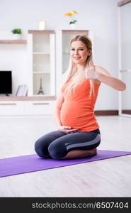 Pregnant woman doing sport exercise at home