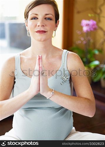 pregnant woman doing yoga at home