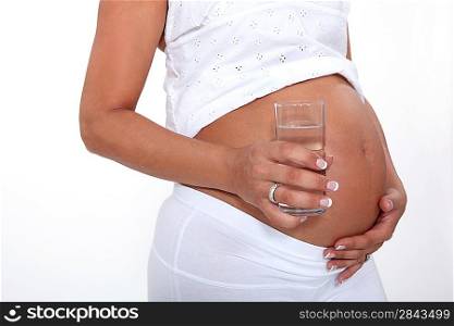 Pregnant woman drinking a glass of water