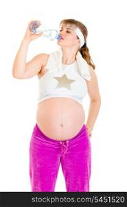 Pregnant woman drinking water from bottle after exercising isolated on white &#xA;
