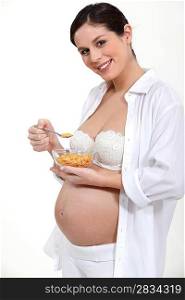 Pregnant woman eating cereal