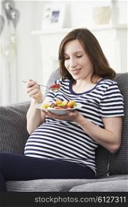 Pregnant Woman Eating Healthy Fruit Salad
