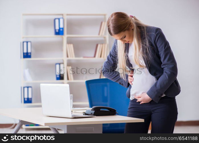 Pregnant woman employee in the office