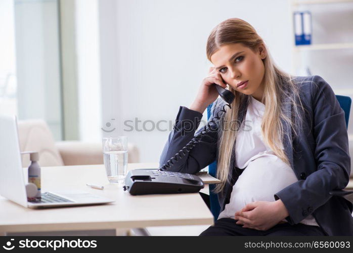 Pregnant woman employee in the office