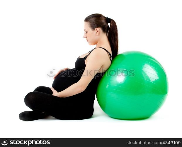 Pregnant woman excercises with gymnastic ball.