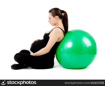 Pregnant woman excercises with gymnastic ball.