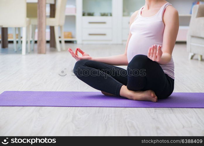 Pregnant woman exercising in anticipation of child birth