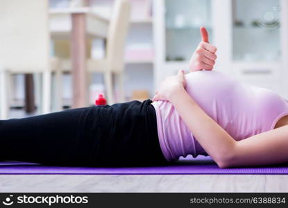 Pregnant woman exercising in anticipation of child birth