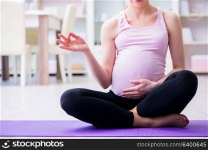 Pregnant woman exercising in anticipation of child birth