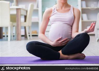Pregnant woman exercising in anticipation of child birth