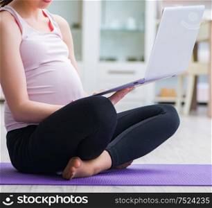 Pregnant woman exercising in anticipation of child birth. The pregnant woman exercising in anticipation of child birth