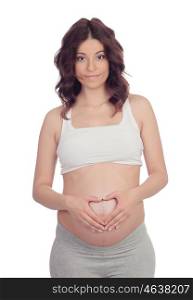 Pregnant woman forming a heart on her belly isolated on white background