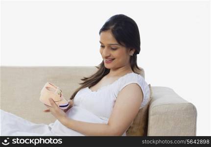 Pregnant woman holding a baby booties