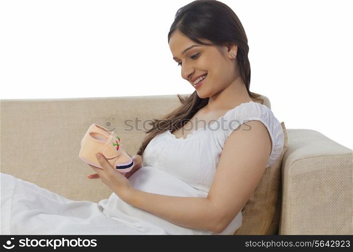 Pregnant woman holding a baby booties