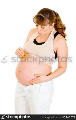 Pregnant woman holding baby dummy near belly isolated on white&#xA;