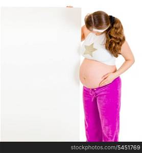 Pregnant woman holding blank billboard isolated on white&#xA;
