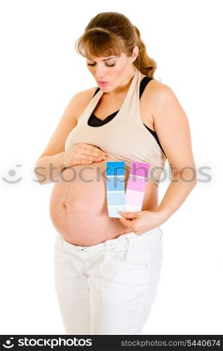 Pregnant woman holding color paint samples and blowing kiss her belly isolated on white&#xA;