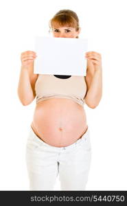 Pregnant woman holding empty white paper in front of her face isolated on white&#xA;