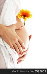 pregnant woman holding her belly and yellow flower