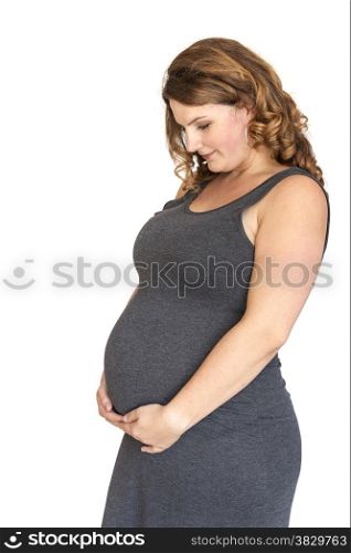 pregnant woman holding her hands on her belly in heart shape