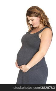 pregnant woman holding her hands on her belly in heart shape