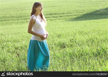 pregnant woman in a summer field