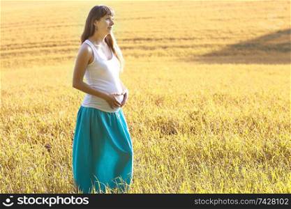 pregnant woman in a summer field