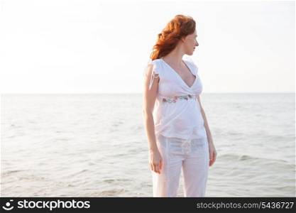 pregnant woman in beach with white light in Mediterranean Spain