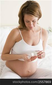 Pregnant woman in bedroom with medicine