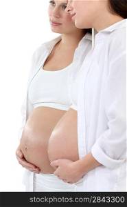 pregnant woman looking herself at the mirror