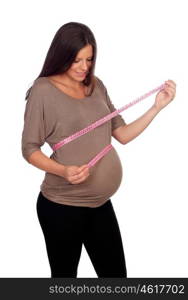 Pregnant woman measuring her belly isolated on a white background