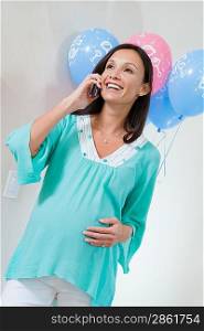 Pregnant Woman on Mobile Phone at a Baby Shower
