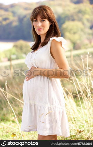 Pregnant woman outdoors in countryside