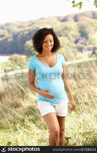 Pregnant woman outdoors in countryside