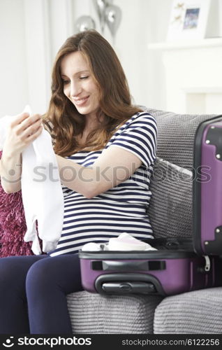 Pregnant Woman Packing Suitcase For Trip To Hospital