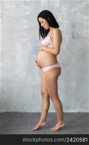 pregnant woman posing underwear