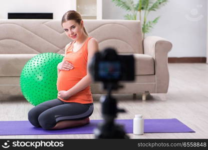 Pregnant woman recording video for blog and vlog