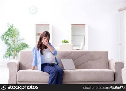 Pregnant woman relaxing on the sofa