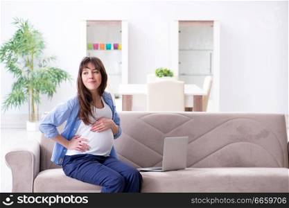 Pregnant woman relaxing on the sofa