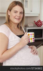 Pregnant Woman Relaxing With Hot Drink