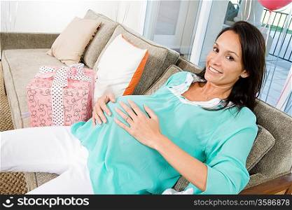 Pregnant Woman resting on Couch at Baby Shower