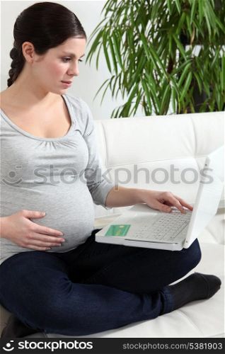 Pregnant woman sat at home