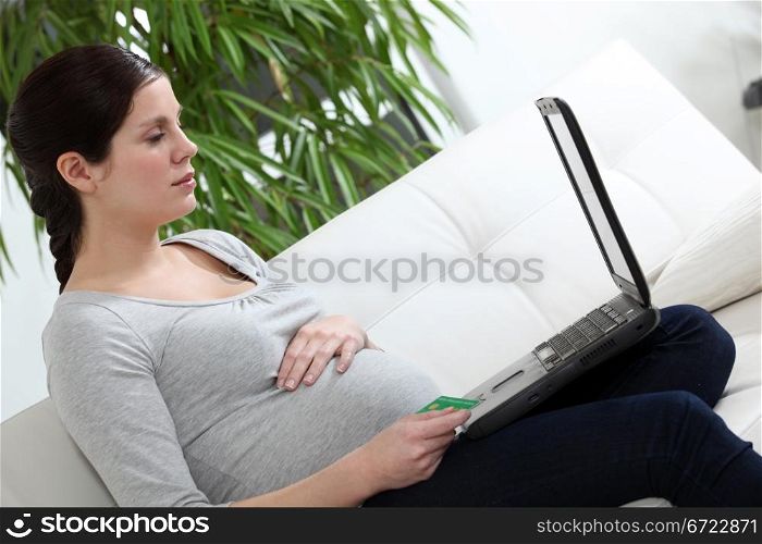 Pregnant woman sat on sofa