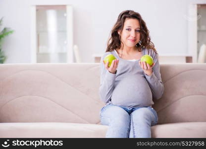 Pregnant woman sitting on sofa