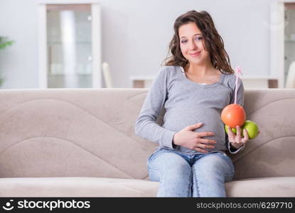 Pregnant woman sitting on sofa