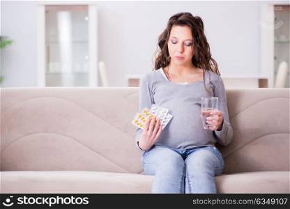 Pregnant woman sitting on sofa