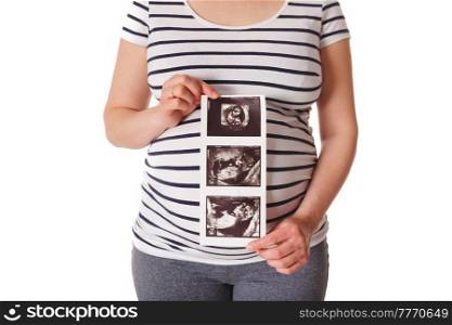Pregnant woman standing and holding her ultrasound baby scan picture isolated on white. Pregnant woman standing and holding her ultrasound baby scan